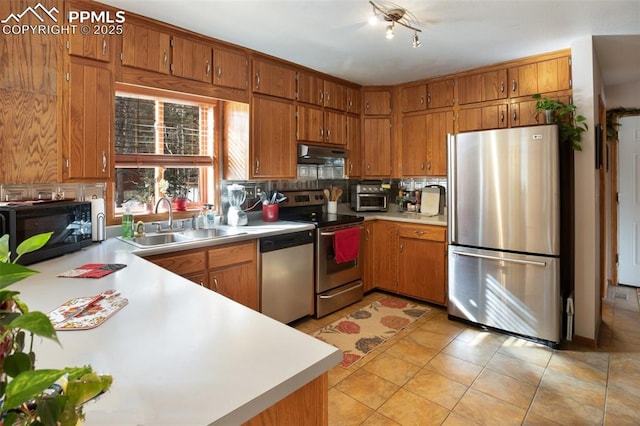 kitchen featuring extractor fan, appliances with stainless steel finishes, sink, backsplash, and light tile patterned floors