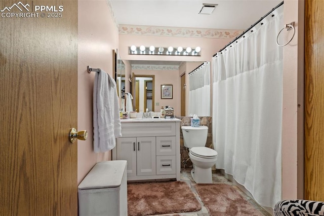 bathroom featuring toilet and vanity