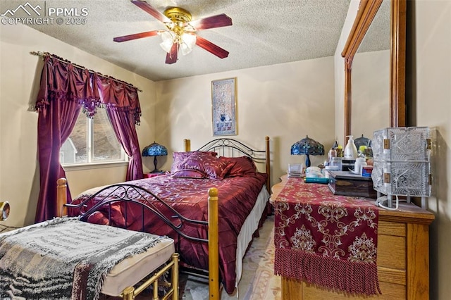 bedroom with a textured ceiling and ceiling fan