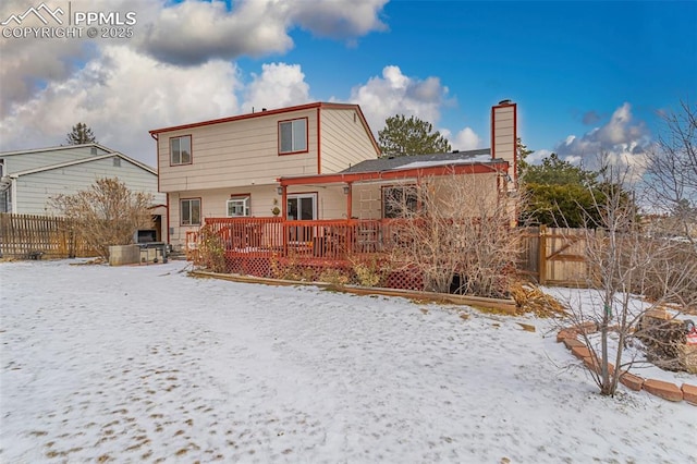 snow covered property with a deck