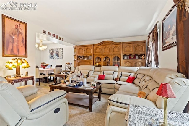 carpeted living room featuring a chandelier