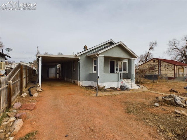 view of front of home with a porch and a carport