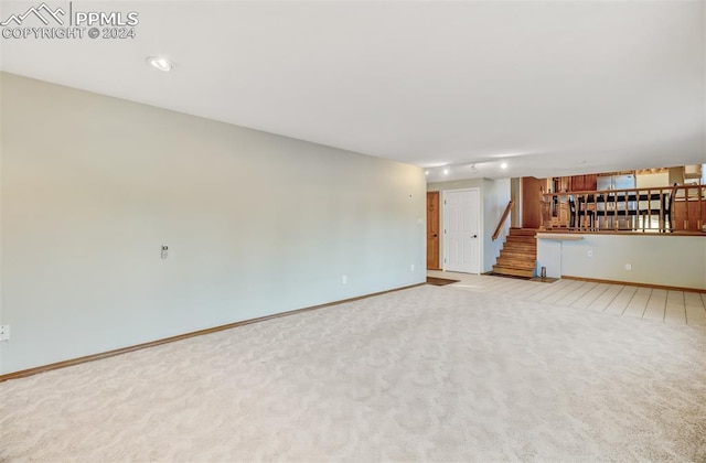 unfurnished living room with light carpet