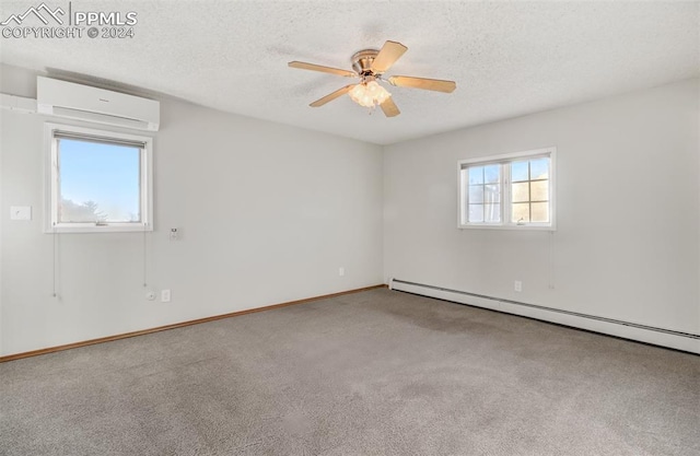 empty room featuring an AC wall unit, carpet floors, a wealth of natural light, and a baseboard heating unit