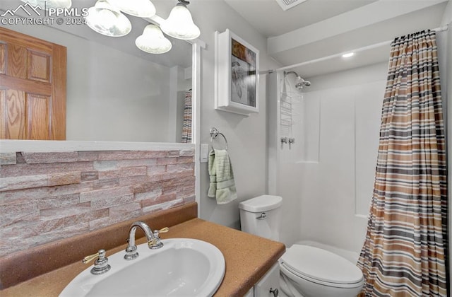 bathroom with vanity, toilet, and walk in shower