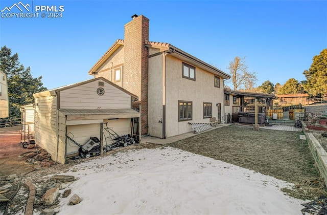 back of house featuring a hot tub