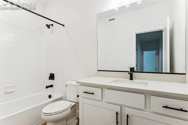 full bathroom with vanity, tiled shower / bath combo, and toilet