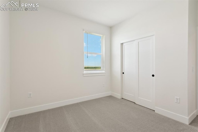 unfurnished bedroom with light colored carpet