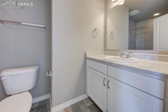 bathroom with vanity, wood-type flooring, and toilet