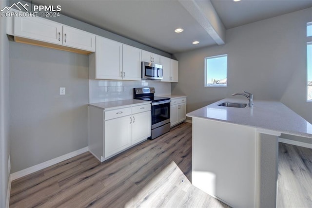 kitchen with white cabinetry, sink, and appliances with stainless steel finishes