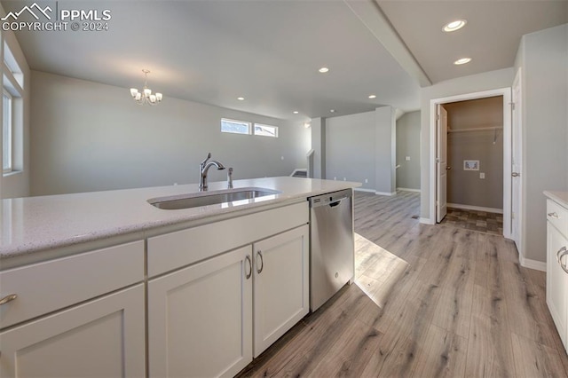 kitchen featuring dishwasher, sink, light hardwood / wood-style flooring, decorative light fixtures, and white cabinetry