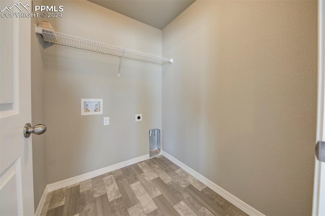 washroom featuring electric dryer hookup, light hardwood / wood-style floors, and hookup for a washing machine