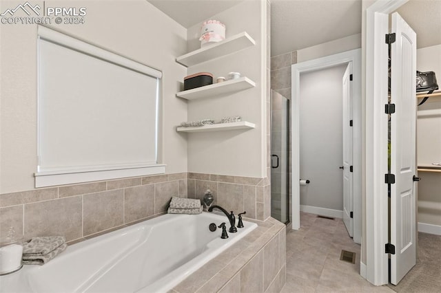 bathroom featuring tile patterned floors and plus walk in shower