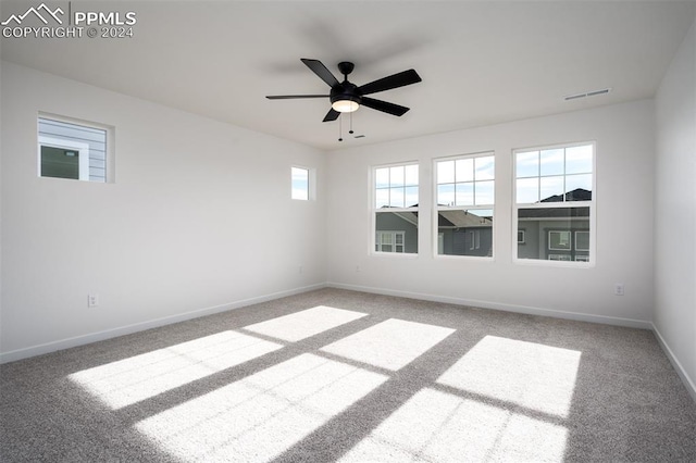 empty room with ceiling fan and carpet floors