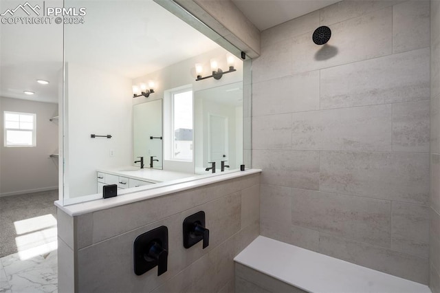 bathroom featuring vanity and tiled shower