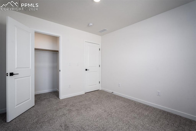 unfurnished bedroom with a closet and carpet