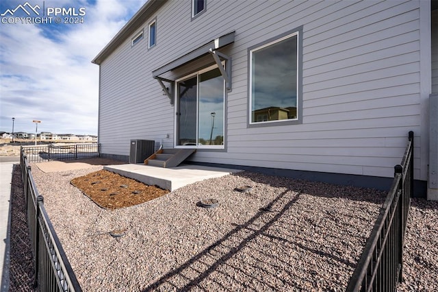 back of house featuring central AC and a patio area