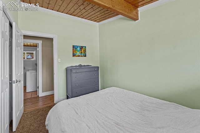 bedroom featuring beamed ceiling, wooden ceiling, and dark colored carpet