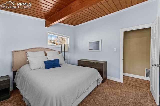 bedroom featuring carpet flooring, beam ceiling, wood ceiling, and ornamental molding