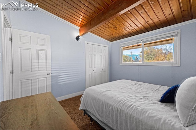 bedroom with vaulted ceiling with beams, a closet, carpet floors, and wooden ceiling