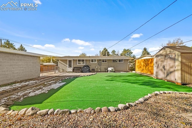 back of property featuring a lawn, a patio area, and a storage shed