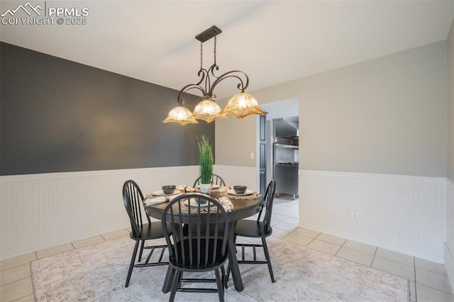 dining room featuring light tile patterned floors and an inviting chandelier