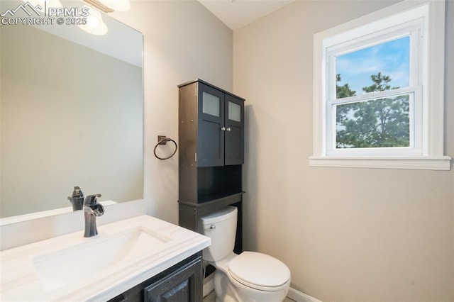 bathroom featuring vanity and toilet