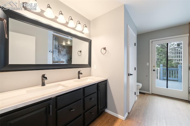 bathroom with hardwood / wood-style floors, vanity, and toilet