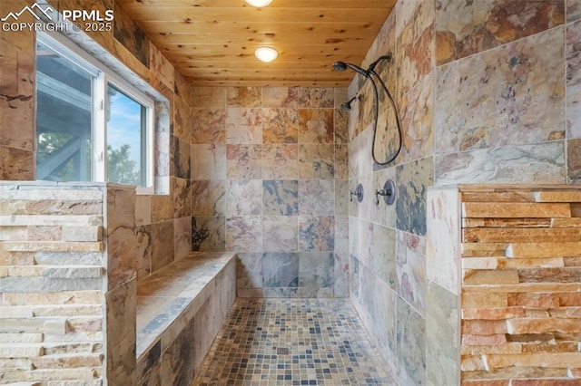 bathroom with a tile shower and wood ceiling