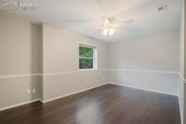 empty room with ceiling fan and dark wood-type flooring