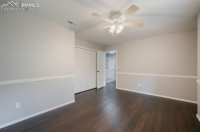 spare room with dark hardwood / wood-style floors and ceiling fan