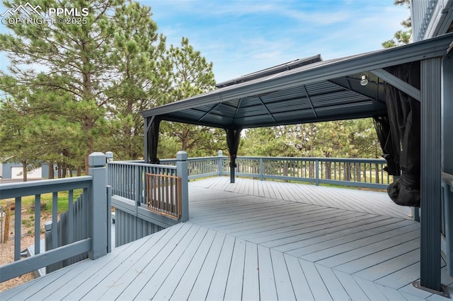 wooden terrace featuring a gazebo