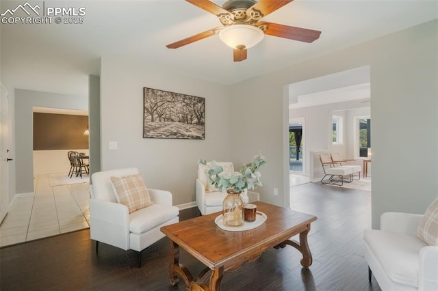 sitting room featuring wood-type flooring and ceiling fan