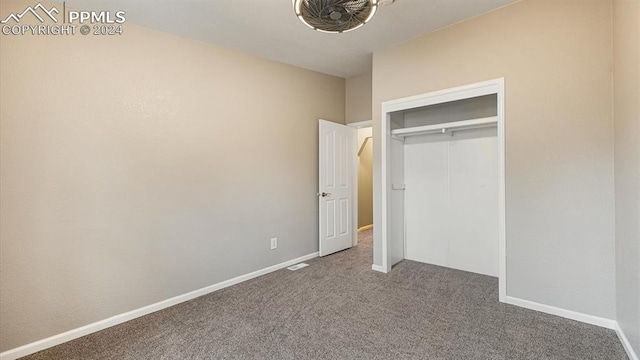 unfurnished bedroom with carpet floors and a closet