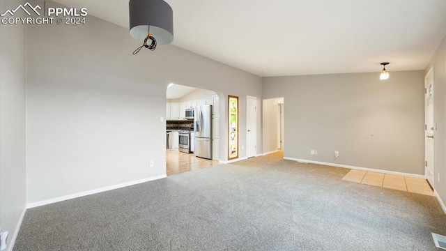 unfurnished living room featuring light carpet