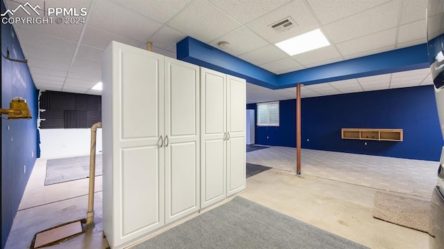 hallway featuring a drop ceiling