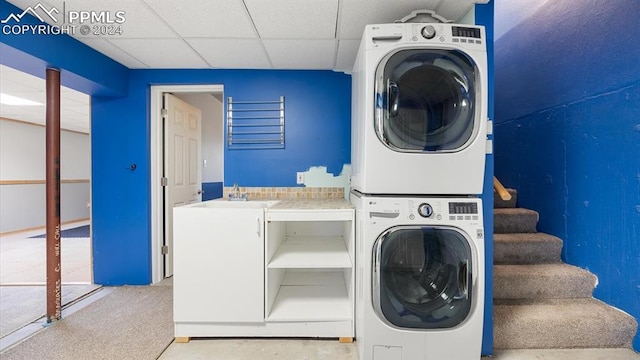 clothes washing area featuring carpet and stacked washer / drying machine