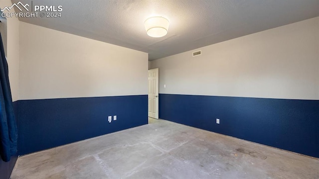 empty room with a textured ceiling