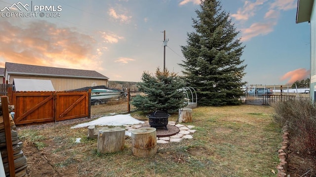 yard at dusk with an outdoor fire pit