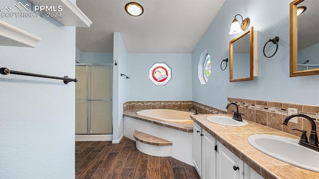 bathroom featuring vanity and separate shower and tub