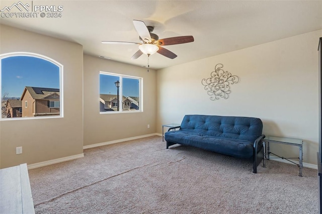 living area with carpet flooring and ceiling fan