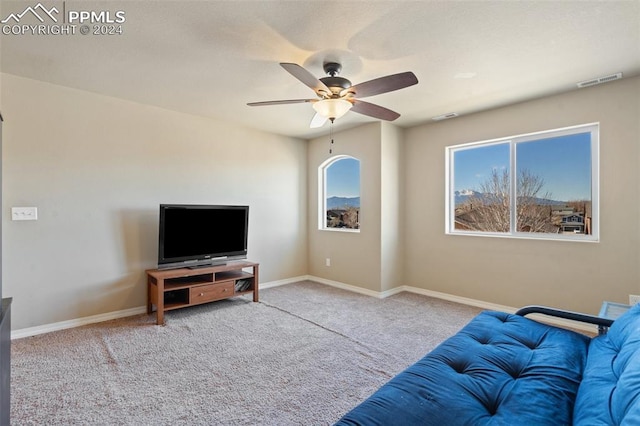 living room featuring light carpet and ceiling fan