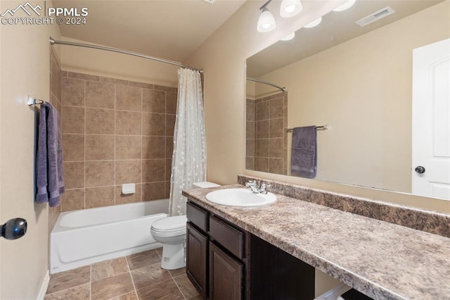 full bathroom featuring vanity, shower / tub combo, and toilet