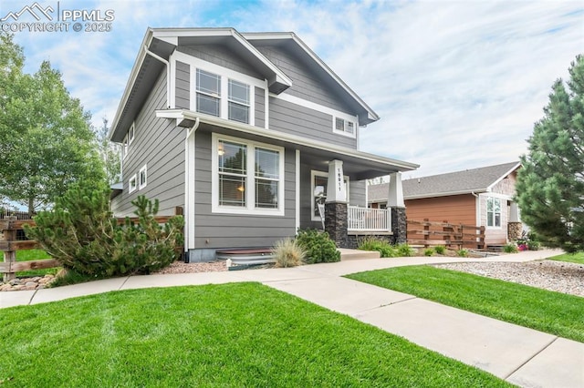 craftsman-style house with covered porch and a front yard