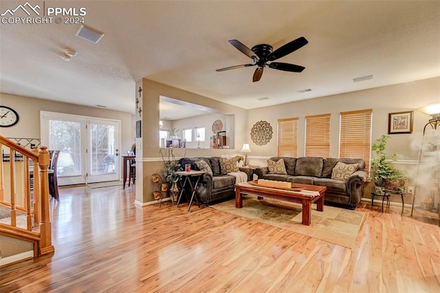 living room featuring ceiling fan and light hardwood / wood-style floors