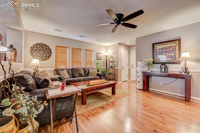 living room with light hardwood / wood-style floors and ceiling fan