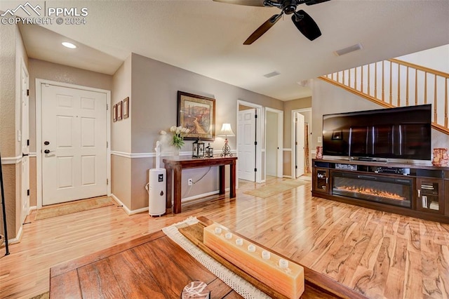 living room with hardwood / wood-style floors and ceiling fan