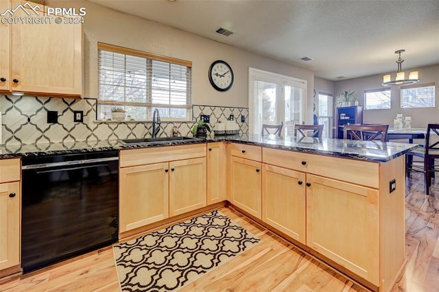 kitchen featuring kitchen peninsula, dishwasher, light hardwood / wood-style flooring, and sink