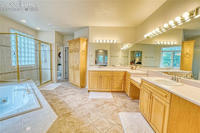 full bathroom with tile patterned flooring, shower with separate bathtub, vanity, and toilet