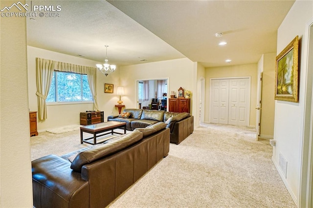 living room featuring light carpet and an inviting chandelier